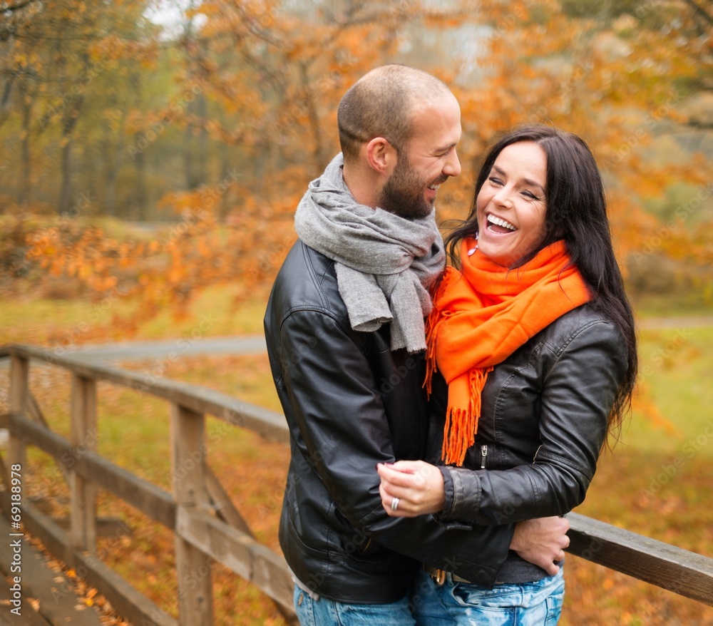 Happy middle-aged couple outdoors on an autumn day Happy middle-aged couple outdoors on an autumn day