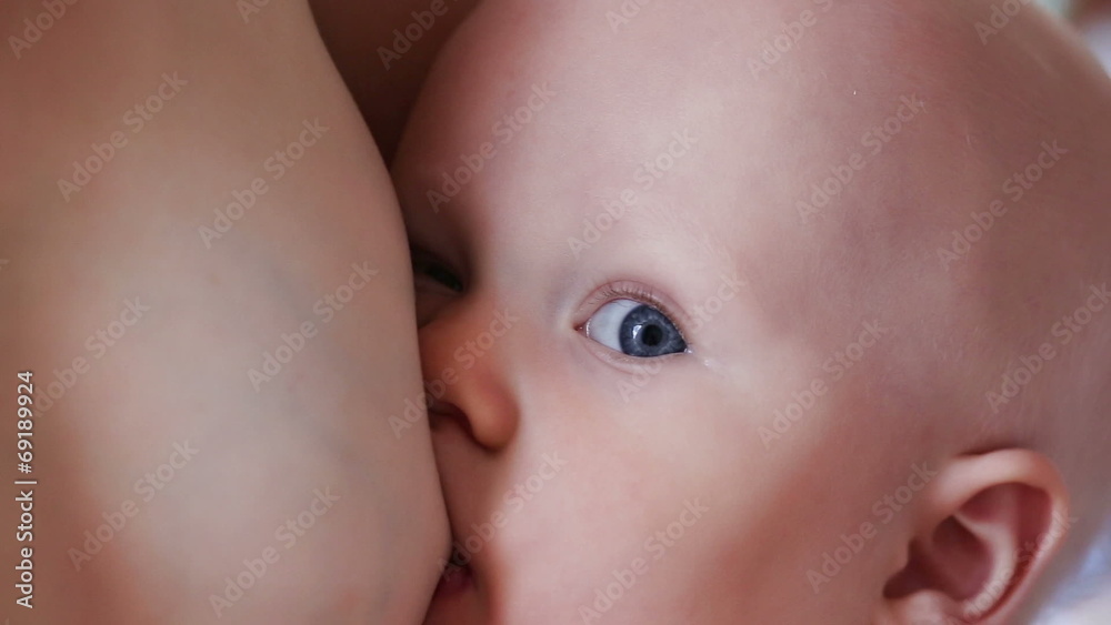 baby sucks mother's breast closeup baby sucks mother's breast closeup