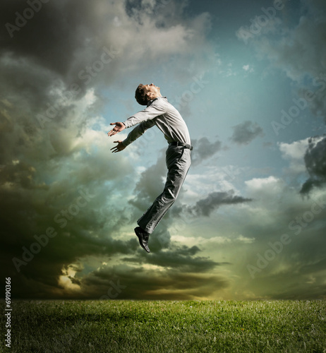Photography Young man jumping up to Sky