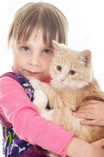Happy little girl with a red kitten.