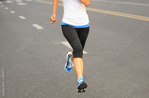 Runner athlete running on city road