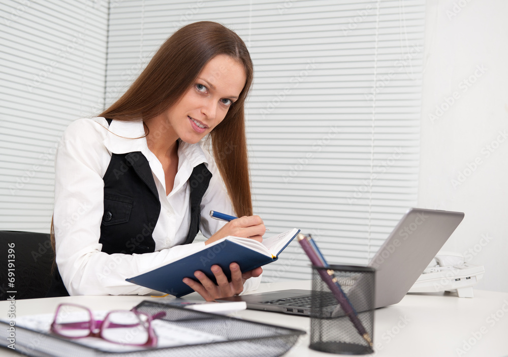 business woman with notebook in the office business woman with notebook in the office