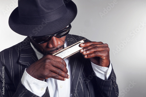 musician plays the harmonica photo