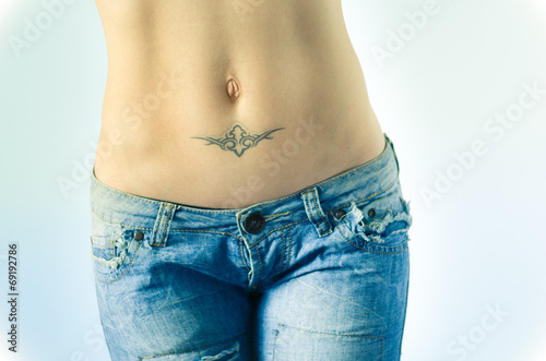 Photography Woman's belly with tattoo in jeans