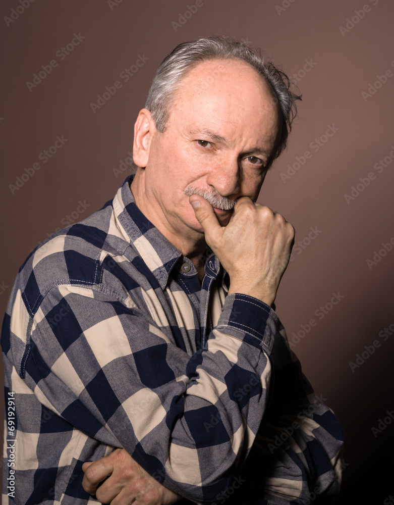 Portrait of smiling handsome senior man looking at the camera o Portrait of smiling handsome senior man looking at the camera o