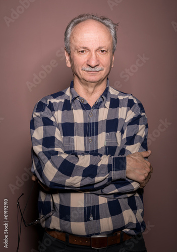 Portrait of smiling handsome senior man looking at the camera o