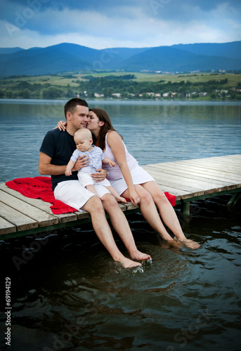 Family with baby on pier © Halfpoint