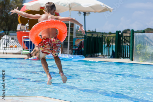 Boy jumping to the pool