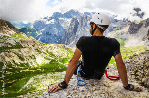 Climber on via ferrata Torre di Toblin, resting on the top photo