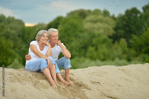 Amusing elderly couple on the beach