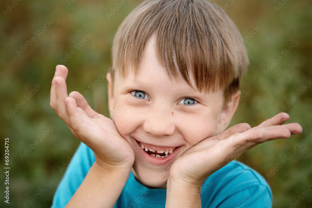 Gray-eyed boy looking at the camera and laughing Gray-eyed boy looking at the camera and laughing