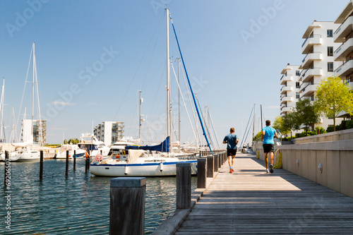 Two men running at the waterfront photo