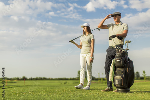 Young couple at golf cart