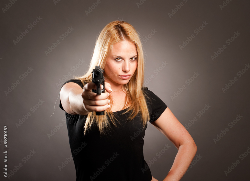 woman with a gun on gray background woman with a gun on gray background
