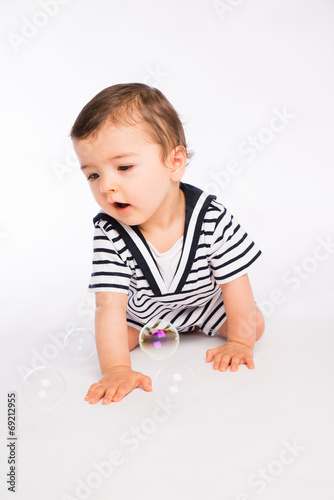 isolated studio portrait lovely toddler baby boy playing
