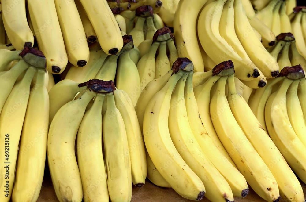 Fresh organic healthy yellow bananas on a market stall.