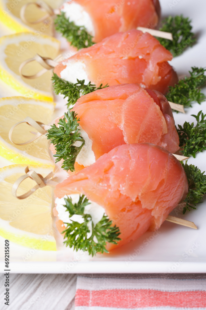 rolls with salmon, cream cheese and lemon closeup rolls with salmon, cream cheese and lemon closeup