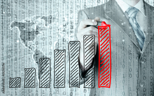 Business man drawing a growing graph