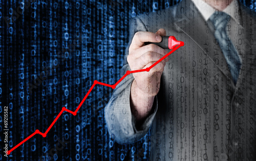 Business man drawing a growing graph