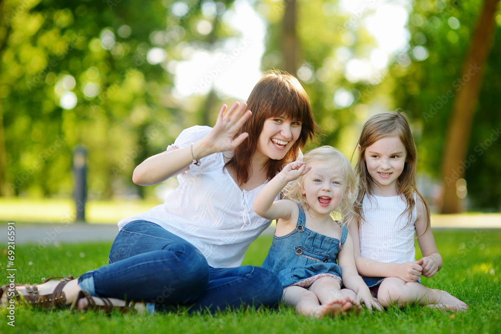 Young beautiful woman and two little kids hugging Young beautiful woman and two little kids hugging