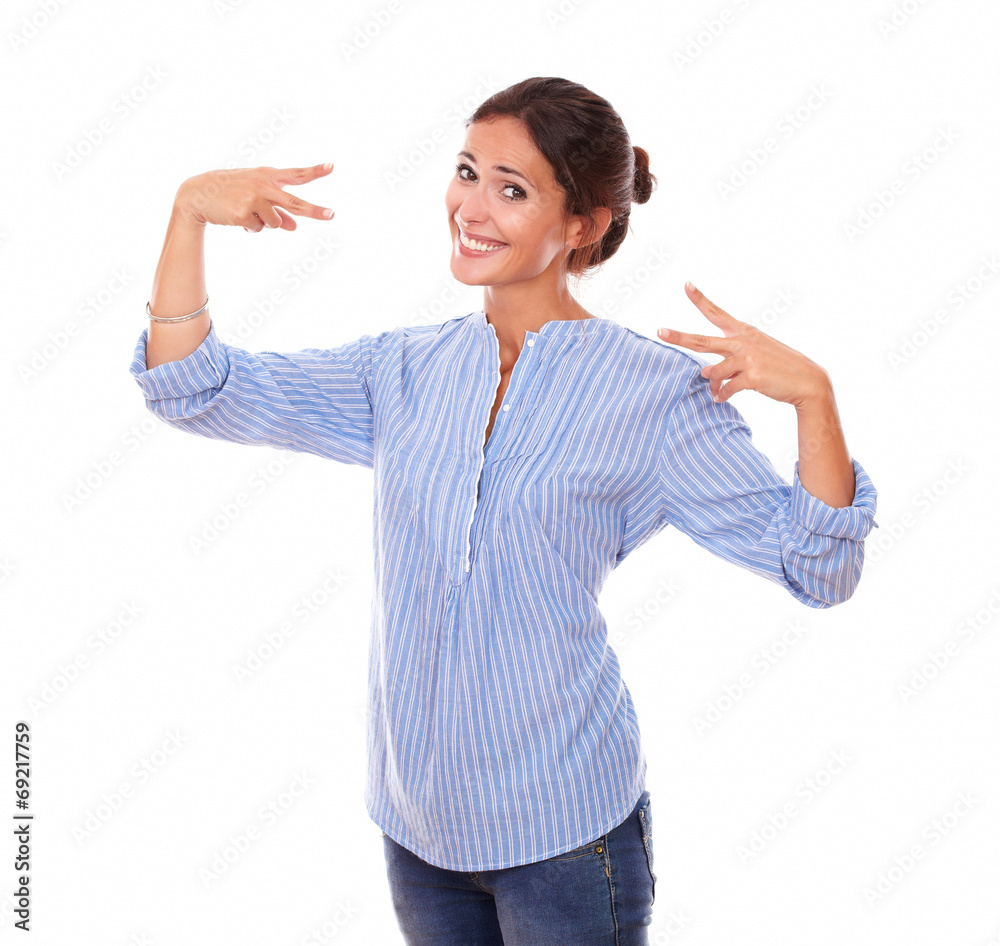 Adult brunette on blue blouse with victory sign Adult brunette on blue blouse with victory sign