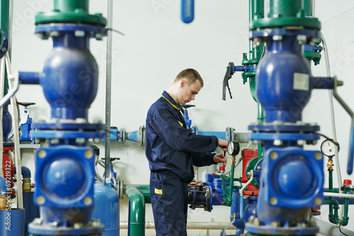 heating engineer repairman in boiler room photo