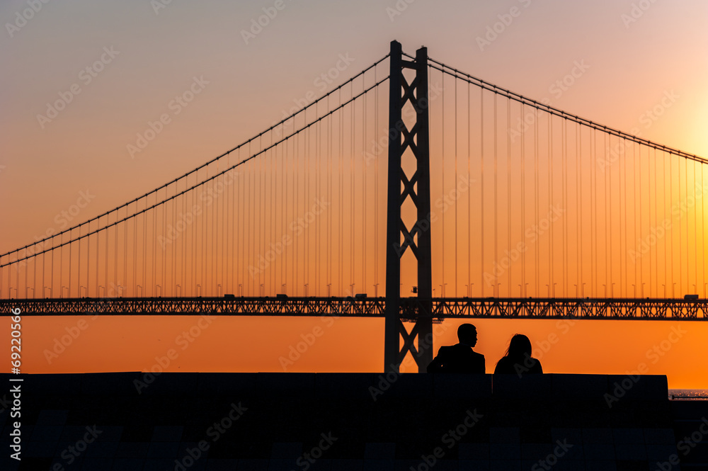Fototapeta premium silhouette couple sitting together with bridge