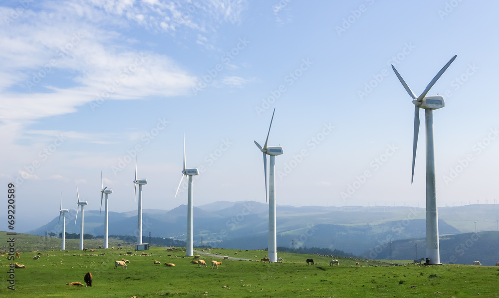 Wind farm in a green field - renewable energy Wind farm in a green field - renewable energy