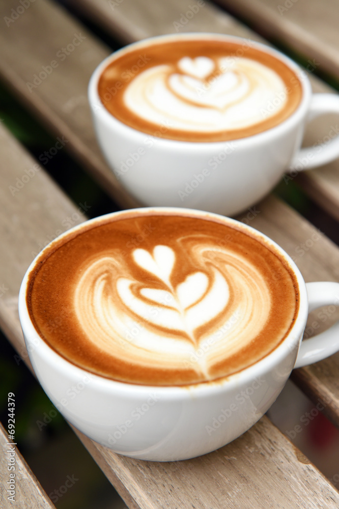 cup of latte art coffee on table cup of latte art coffee on table