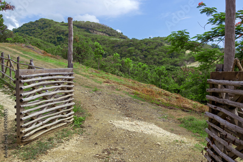 Open gate and road  hill landscape as background