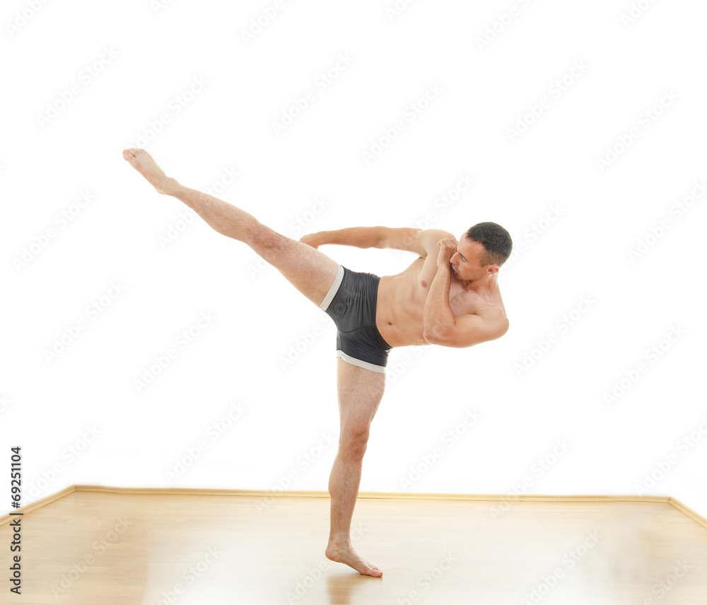 Powerful fighter attack position portrait with a kick Powerful fighter attack position portrait with a kick