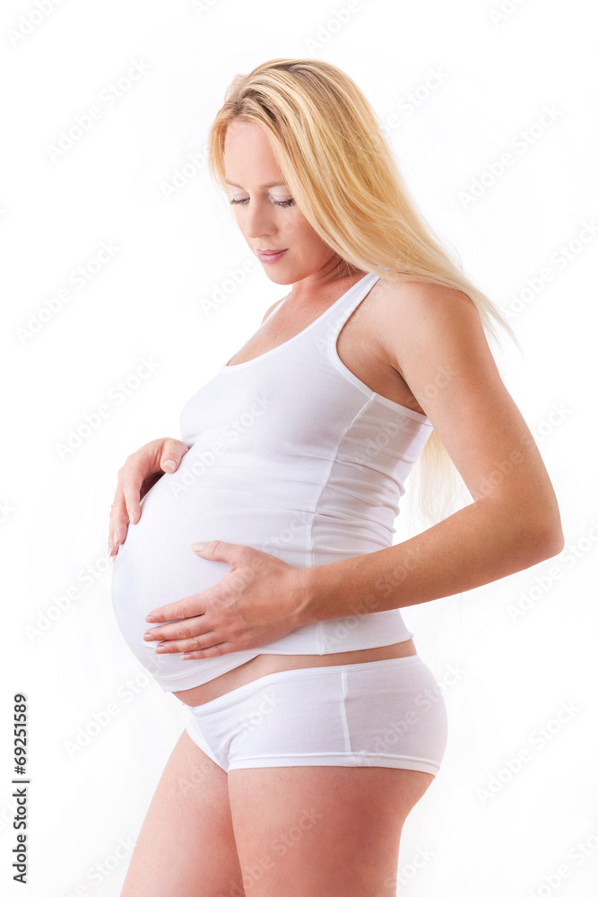 Pregnant woman caressing her belly with white background Pregnant woman caressing her belly with white background