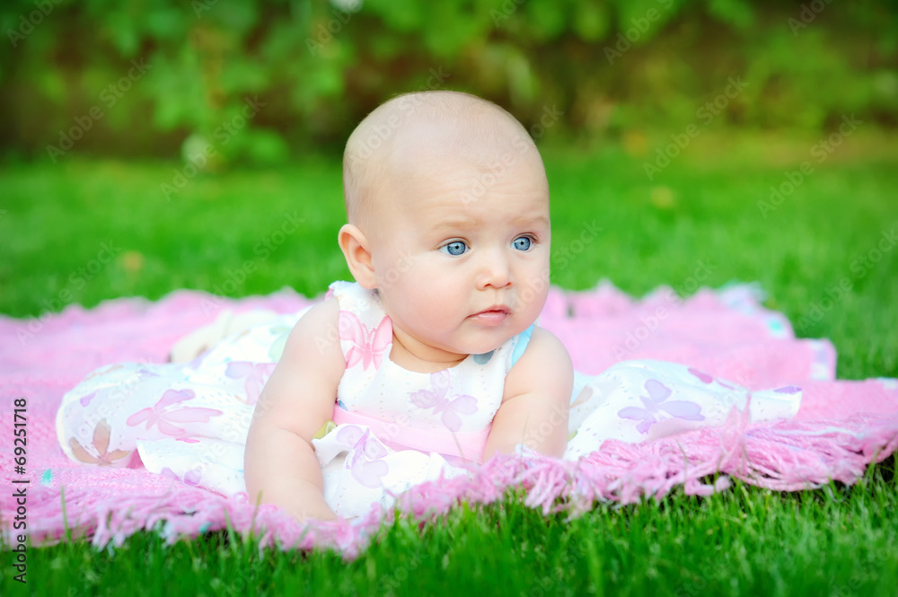baby smiling and looking up to camera outdoors in sunlight baby smiling and looking up to camera outdoors in sunlight