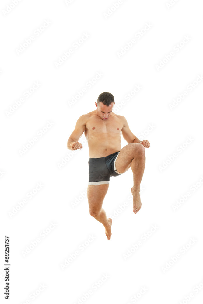 Full length portrait of boxer fighter in kick motion Full length portrait of boxer fighter in kick motion