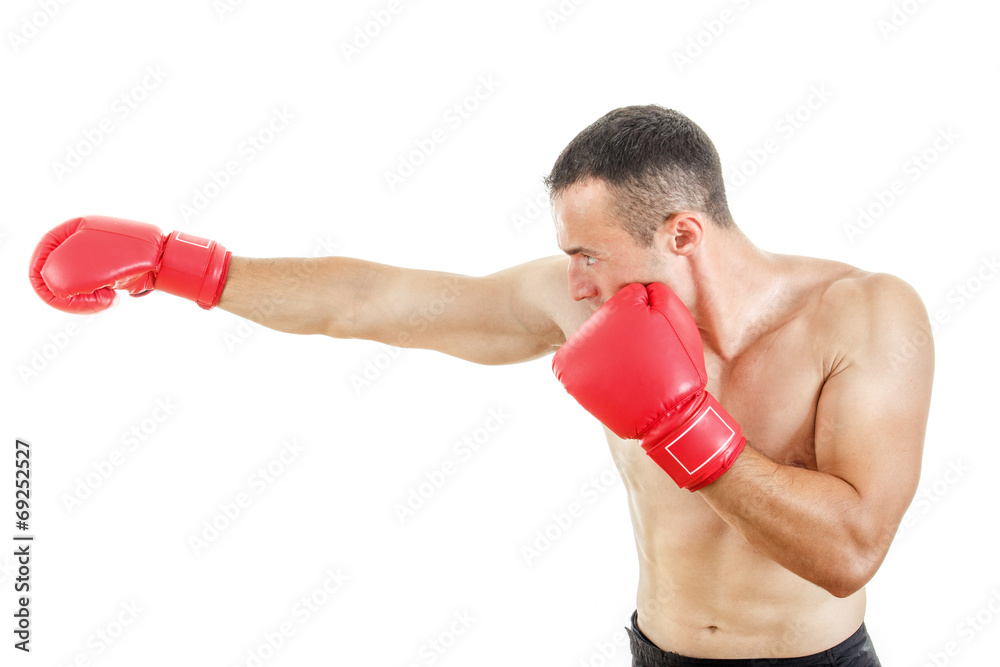 side view of muscular man wearing red boxing gloves and punching
