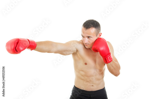 Side view of muscular male boxer hitting straight against a whit