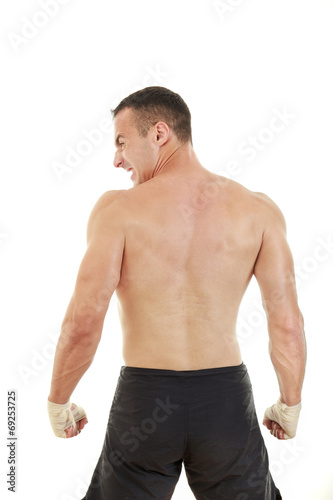 furious athletic fighter with bandages on hands in fight positio