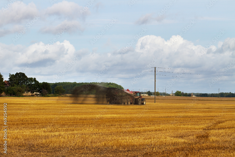 Fototapeta premium Tractor on the field.