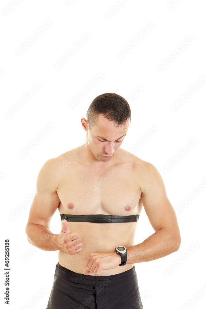 Fototapeta premium Man measuring heart beat and pulse with chest strap