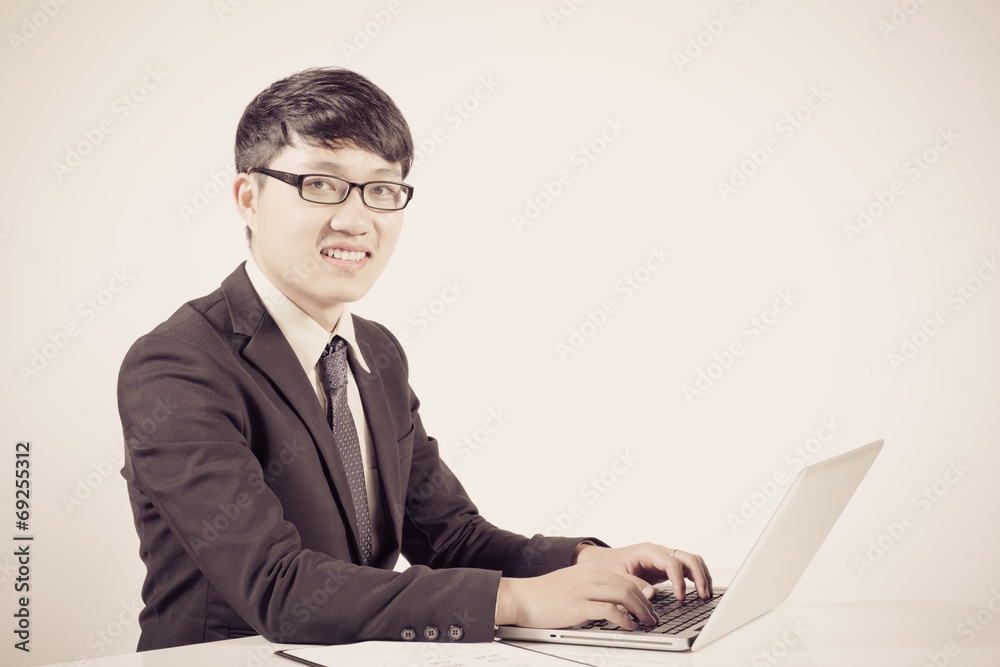 Asian business man using laptop computer isolated on white backg Asian business man using laptop computer isolated on white backg