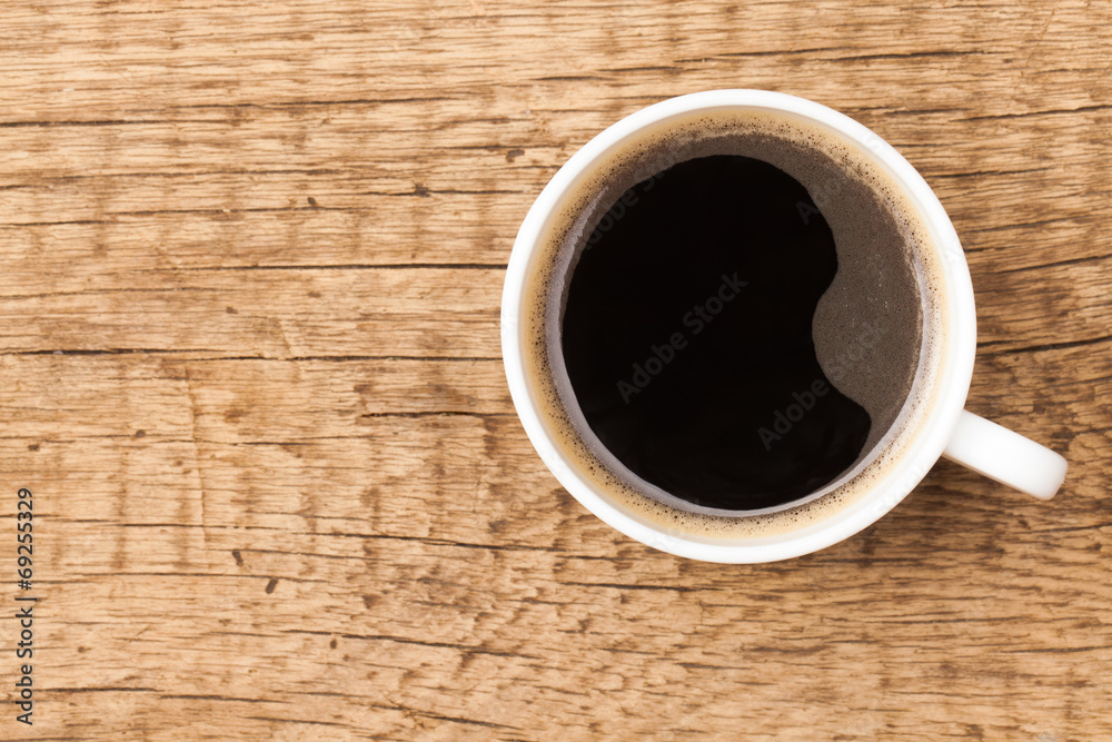 Black coffee in white ceramic cup on wooden table Black coffee in white ceramic cup on wooden table