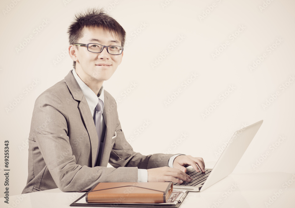 Asian business man using laptop computer isolated on white backg Asian business man using laptop computer isolated on white backg