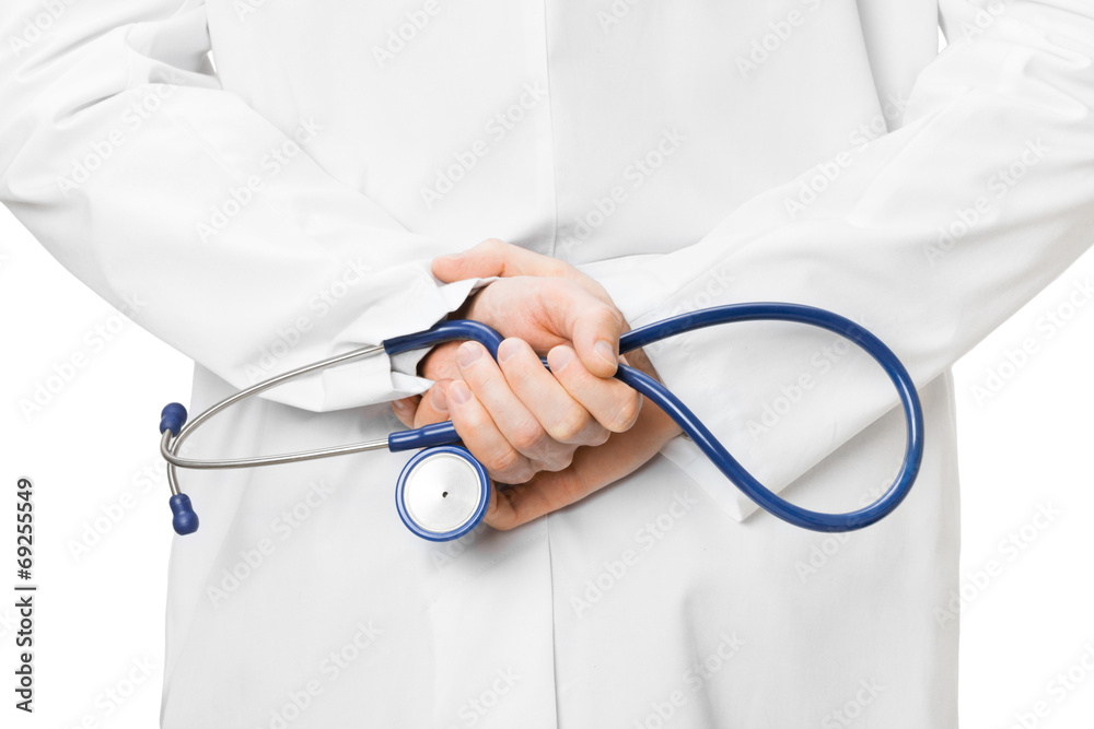 Doctor with a stethoscope and hands crossed behind his back Doctor with a stethoscope and hands crossed behind his back