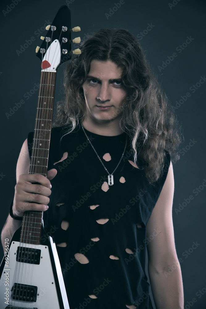 Obraz premium Male hard rock electric guitar musician with long hair. Studio s