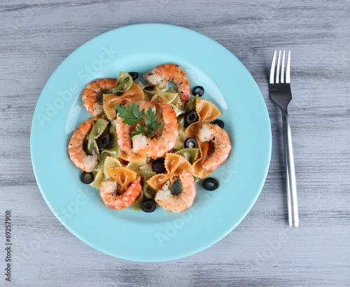 Fresh prawns with coloured macaroni, olives and parsley in a