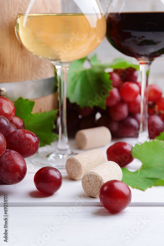 Wine with grapes on table close-up
