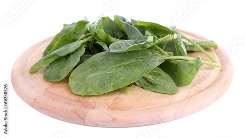 Tuft of fresh sorrel on wooden cutting board isolated on white
