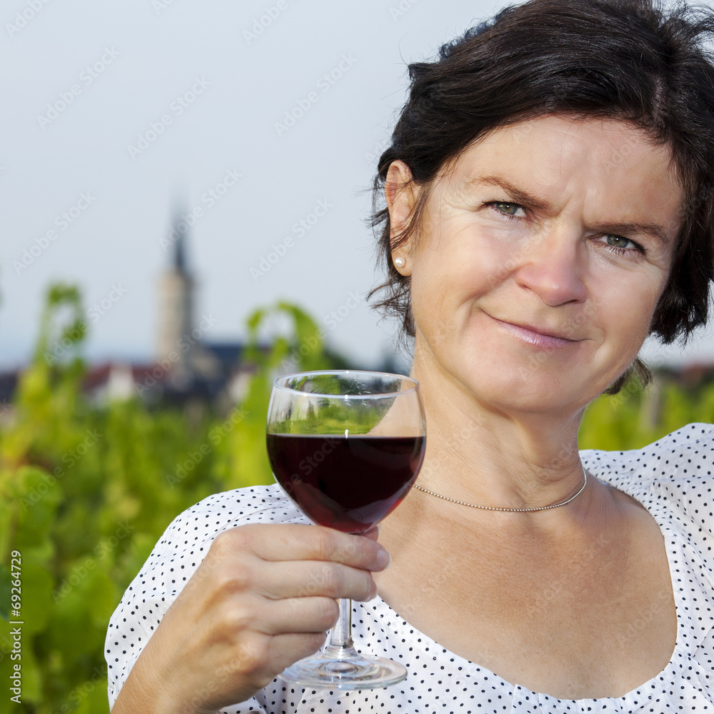 Woman with glass of red wine in vineyard Woman with glass of red wine in vineyard