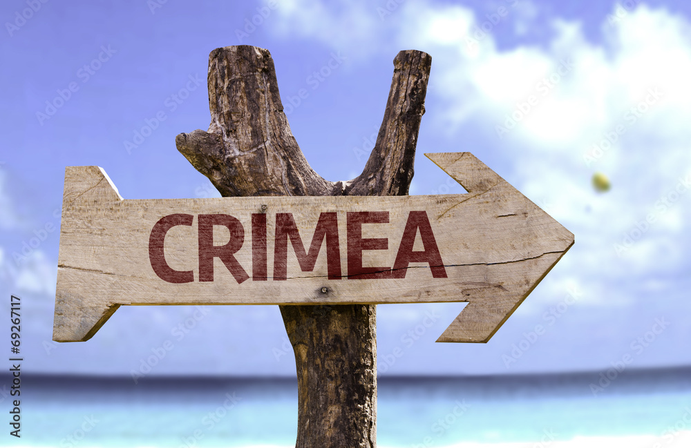 Crimea wooden sign with a beach on background