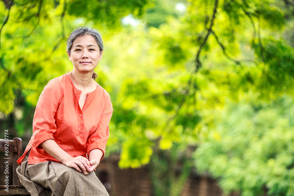 Portrait of serene mature woman in garden Portrait of serene mature woman in garden